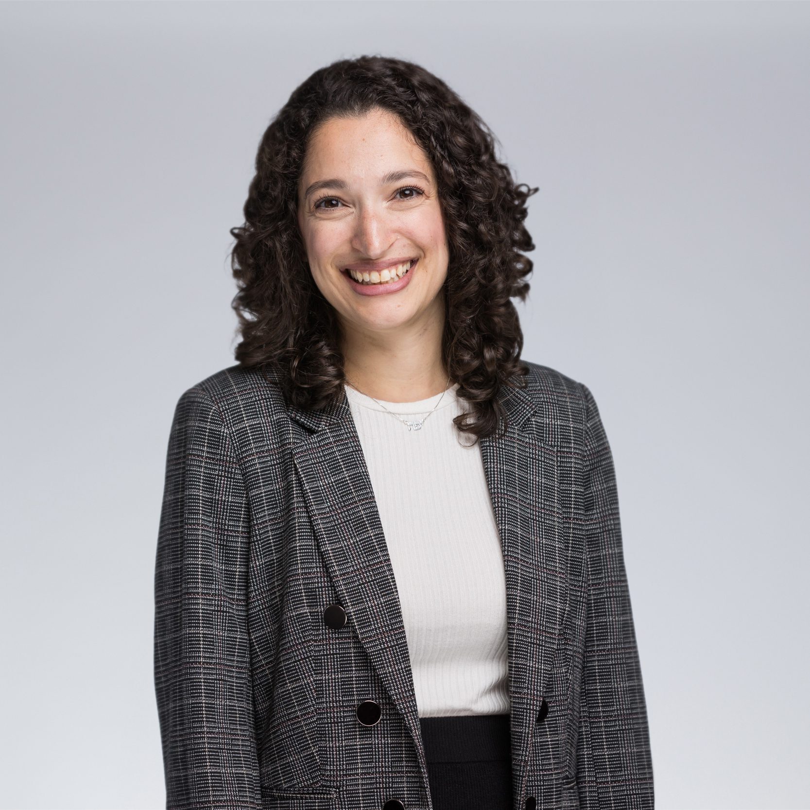 A diverse crowd of people celebrating at a concert, raising their hands and cheering.