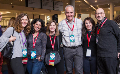 Group of three smiling parents at a community event