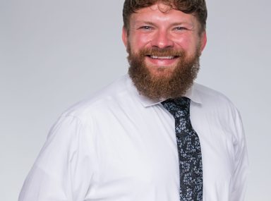 Una multitud diversa de personas celebrando en un concierto, levantando las manos y vitoreando.