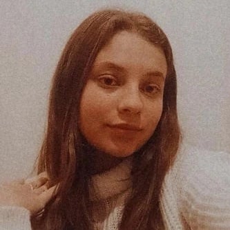 A diverse group of young adults jumping with excitement in a lush green garden during a community event.